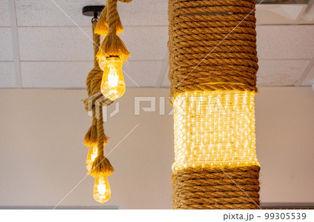 Interior view of a restaurant with bulb, rope decoration 99305539