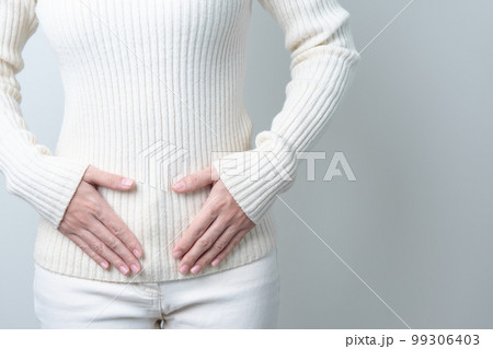 Woman holding  her belly. Pregnancy, Reproductive system, menstruation, and gynecology concept 99306403