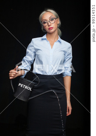 Businesswoman with watering can and word petrol. Oil, petrol, energy, business concept 99314551