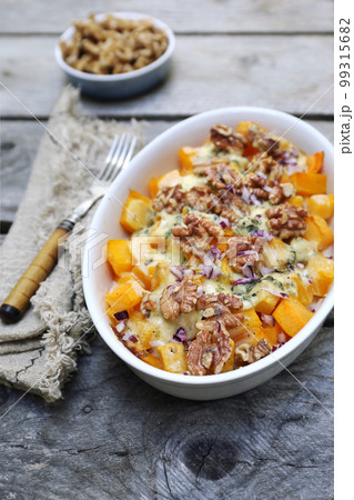 Baked pumpkin with blue cheese and walnuts, gratin Baked pumpkin with blue cheese and walnuts, gratin 99315682