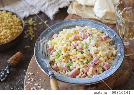 Italian Cuisine. Stortini pasta with fresh ham cubes, parmesan cheese and glass of white wine 99316141