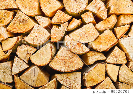 Firewood background. Preparation of firewood for the winter. Pile of firewood. 99320705