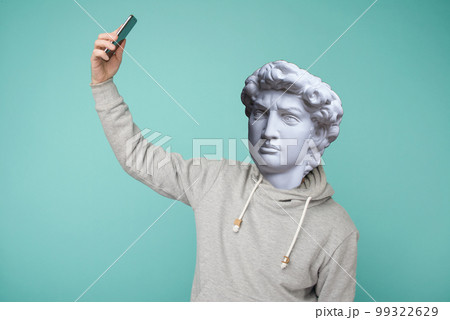 Abstract modern collage. The man with the plaster head of David leading a conference on a smartphone 99322629