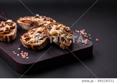 Delicious crispy toast or bruschetta with fried onion, champignon mushrooms and cheese Delicious crispy toast or bruschetta with fried onion, champignon mushrooms and cheese 99328331