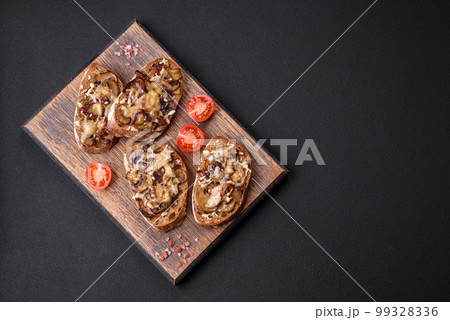 Delicious crispy toast or bruschetta with fried onion, champignon mushrooms and cheese 99328336