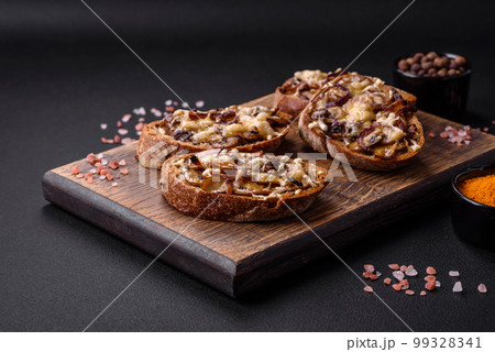 Delicious crispy toast or bruschetta with fried onion, champignon mushrooms and cheese 99328341