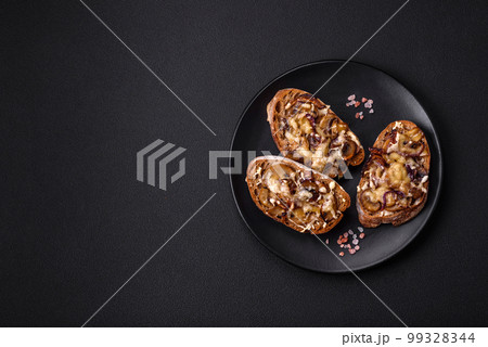 Delicious crispy toast or bruschetta with fried onion, champignon mushrooms and cheese 99328344