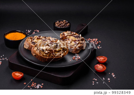 Delicious crispy toast or bruschetta with fried onion, champignon mushrooms and cheese 99328349