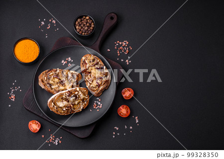 Delicious crispy toast or bruschetta with fried onion, champignon mushrooms and cheese 99328350