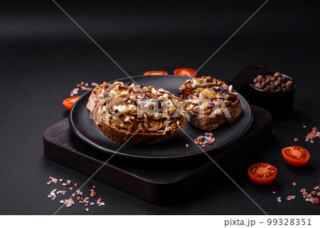 Delicious crispy toast or bruschetta with fried onion, champignon mushrooms and cheese Delicious crispy toast or bruschetta with fried onion, champignon mushrooms and cheese 99328351