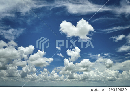 White puffy cumulus clouds on summer blue sky 99330820