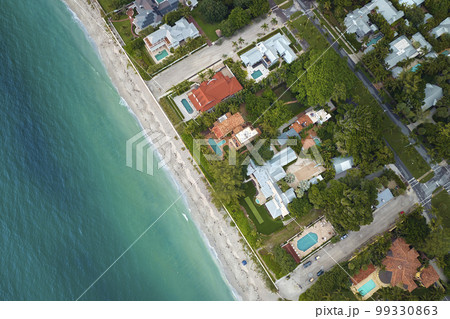View from above of large residential houses in island small town Boca Grande on Gasparilla Island in southwest Florida. American dream homes as example of real estate development in US suburbs View from above of large residential houses in island small town Boca Grande on Gasparilla Island in southwest Florida. American dream homes as example of real estate development in US suburbs 99330863