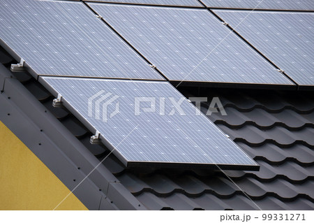 Residential house with rooftop covered with solar photovoltaic panels for producing of clean ecological electrical energy in suburban rural area. Concept of autonomous home Residential house with rooftop covered with solar photovoltaic panels for producing of clean ecological electrical energy in suburban rural area. Concept of autonomous home 99331271