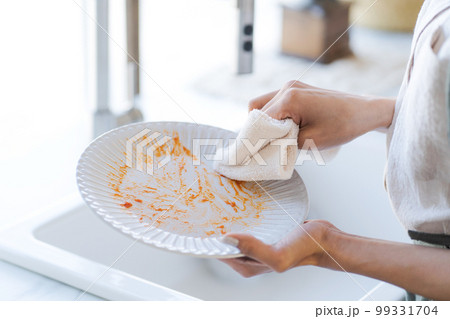 食器の油汚れを拭き取る写真 99331704