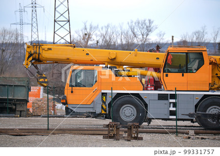 Heavy duty mobile lifting crane at construction site Heavy duty mobile lifting crane at construction site 99331757