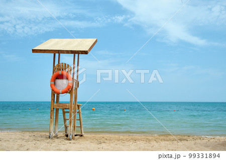 Emplty wooden lifeguard station on sandy beach on ocean shore in summer Emplty wooden lifeguard station on sandy beach on ocean shore in summer 99331894