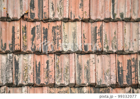 Closeup surface of old weathered ceramic tiles covering building roof Closeup surface of old weathered ceramic tiles covering building roof 99332077