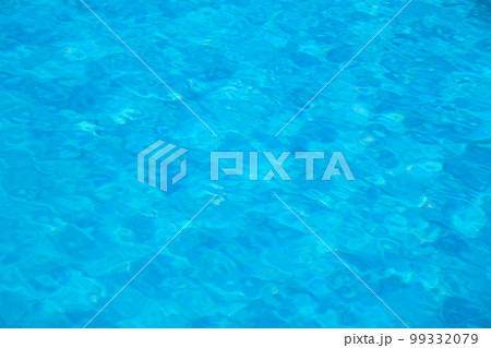 Closeup surface of blue clear water with small ripple waves in swimming pool. Closeup surface of blue clear water with small ripple waves in swimming pool. 99332079