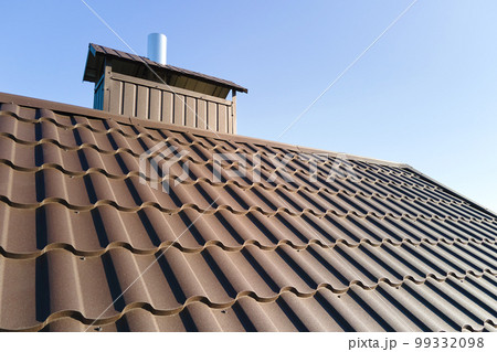 Closeup of house roof top covered with metallic shingles Closeup of house roof top covered with metallic shingles 99332098