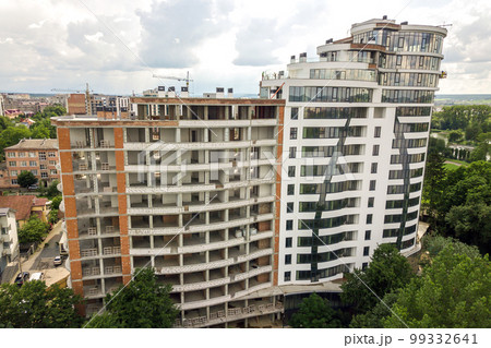 Aerial view of tall residential apartment building under construction. Real estate development. 99332641