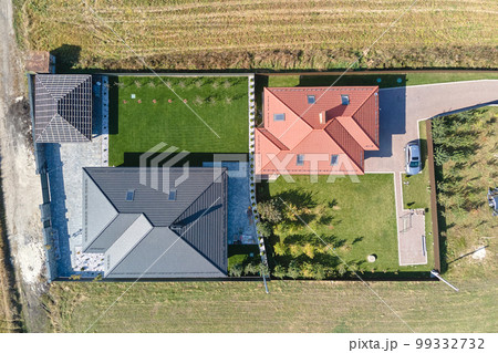 Aerial view of residential house with backyard in suburban rural area Aerial view of residential house with backyard in suburban rural area 99332732