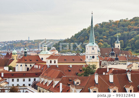 Orange tile roofs and church view, and historical buildings in Prague. Orange tile roofs and church view, and historical buildings in Prague. 99332843