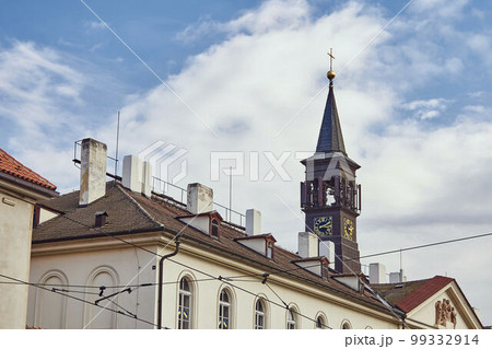 Clock on church tower in Prague against the sky. Clock on church tower in Prague against the sky. 99332914