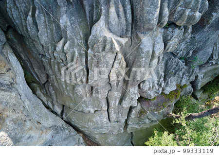 Aerial view of large rocky formations with snone boulders and mountain high cliffs Aerial view of large rocky formations with snone boulders and mountain high cliffs 99333119