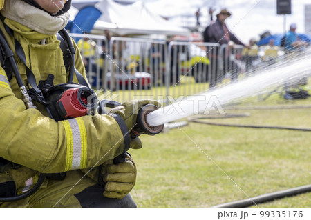 Photograph of water coming out of a fire hose 99335176