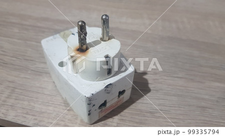Burnout electrical appliances or electrical plug or electrical adapter dangerous 99335794