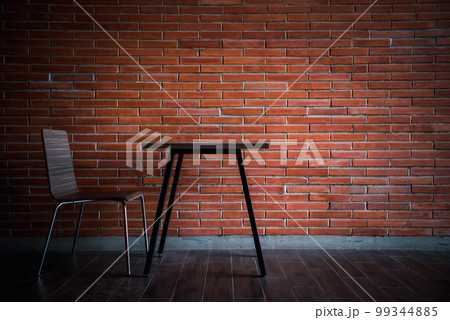 Balcony with red brick wall and table chairs set 99344885