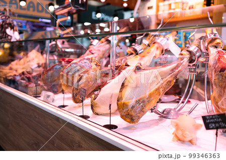 Food store with jamon in La Boqueria market one of the most popular tourist landmark in the Ciudad Vieja district in Barcelona Food store with jamon in La Boqueria market one of the most popular tourist landmark in the Ciudad Vieja district in Barcelona 99346363