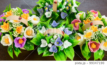 Crocuses, daffodils, handmade soap snowdrops in wicker baskets on a white background Crocuses, daffodils, handmade soap snowdrops in wicker baskets on a white background 99347190