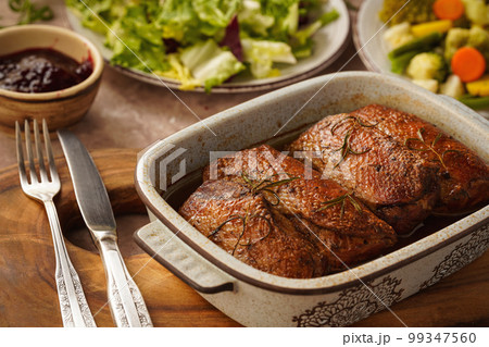 Roasted duck breasts served with vegetables and cranberry dip. Roasted duck breasts served with vegetables and cranberry dip. 99347560