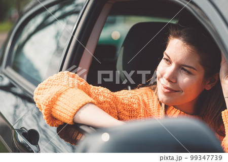Beautiful caucasian woman portrait, fixing her sunglasses while driving in her car Beautiful caucasian woman portrait, fixing her sunglasses while driving in her car 99347739