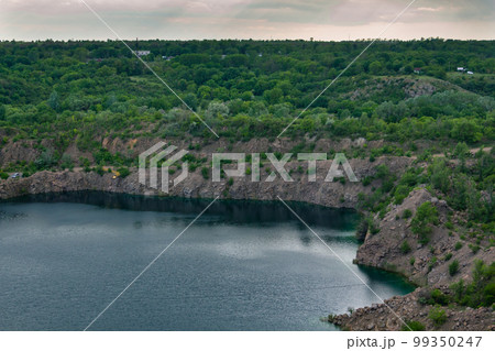 rocky cliff and lake, quarry lakes and beautiful sky after a thunderstorm 99350247