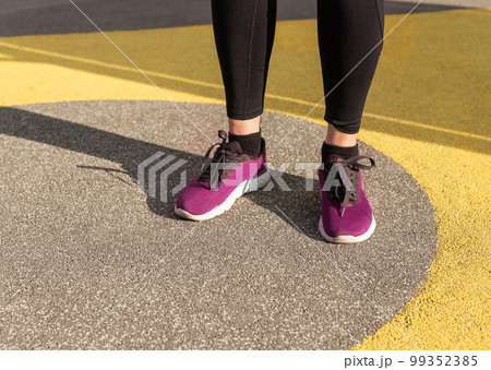 Athlete feet in sneakers. Woman doing sport outdoors. Healthy lifestyle, training concept. 99352385