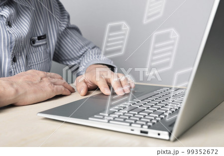 Businessman using laptop for electronic documents, letters sending and receiving. Man sitting at desk with computer. Online communication and paper flow concept. 99352672