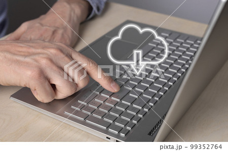 Cloud computing. Man using laptop for download files from remote database. Forefinger closeup pressing on enter button. Online service for storing objects Cloud computing. Man using laptop for download files from remote database. Forefinger closeup pressing on enter button. Online service for storing objects 99352764
