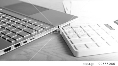 Laptop and calculator at table. Accountant job, workplace. Statistic data, analytic report preparing. Laptop and calculator at table. Accountant job, workplace. Statistic data, analytic report preparing. 99353086
