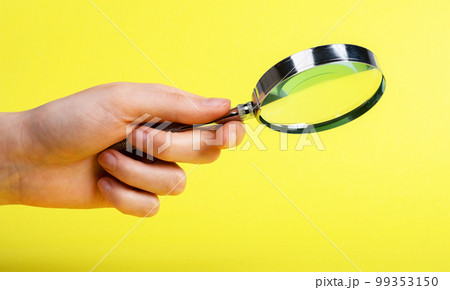 Woman hand with magnifier on yellow background. Information search, analysis and learning, audit conducting. Spy work and looking for evidence Woman hand with magnifier on yellow background. Information search, analysis and learning, audit conducting. Spy work and looking for evidence 99353150
