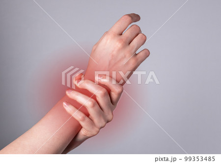 Woman hand holding painful wrist with red spot closeup. Health problems, injury, fatigue, overwork, office syndrome concept. Woman hand holding painful wrist with red spot closeup. Health problems, injury, fatigue, overwork, office syndrome concept. 99353485
