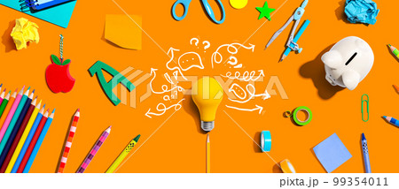 Brainstorming concept with a light bulb and school supplies 99354011