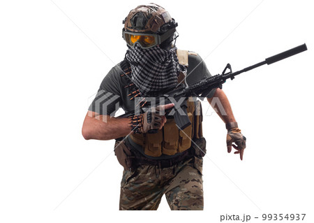 Pprofessional special forces fighter, during a special operation walks with an automatic rifle looking to the side. Pprofessional special forces fighter, during a special operation walks with an automatic rifle looking to the side. 99354937