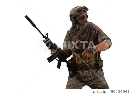 Cropped photo mercenary soldier walks with an automatic rifle in his hand and looking by side. Cropped photo mercenary soldier walks with an automatic rifle in his hand and looking by side. 99354941