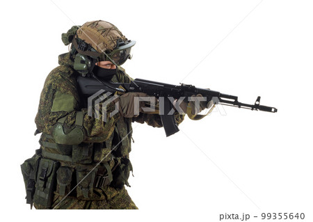 A russian mercenary soldier with AK-74 in his hand and aiming in enemy. 99355640