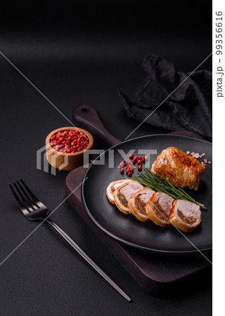 Delicious chicken or pork meat roll with mushrooms, cheese, spices and herbs 99356616