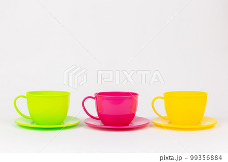multi-colored plastic cups and plates on a white background kitchen set 99356884