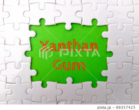 White puzzle with the word Xanthan Gum on a green background. White puzzle with the word Xanthan Gum on a green background. 99357425