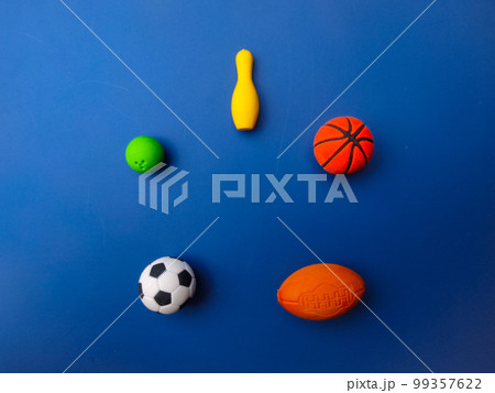 Top view of various sports balls on blue background. Top view of various sports balls on blue background. 99357622